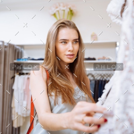 demo-attachment-141-woman-doing-shopping-and-choosing-clothes-in-PDEP6XU